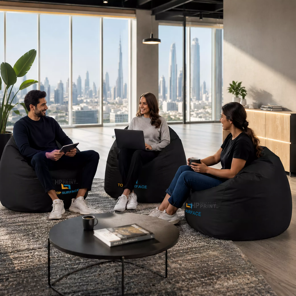 Three people sitting on bean bags in a modern office with cityscape view