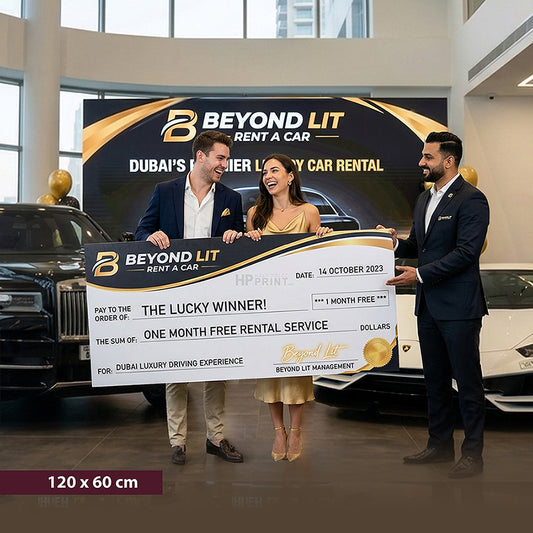 Two men and a woman holding a large cheque in front of a Beyond Lit Rent a Car backdrop.