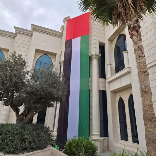 Large building flag with red, white, and green stripes hanging on a building facade.