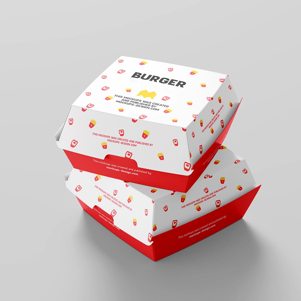 Two stacked red and white burger boxes with playful food icons and bold branding, photographed on a light gray surface.