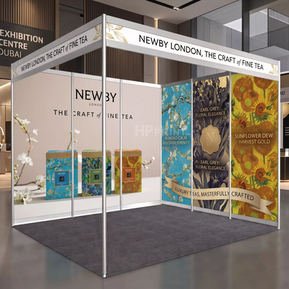 A 3D mockup of a Newby London fine tea exhibition booth, showcasing branded panels, product boxes, and decorative artwork in a modern exhibition hall setting.