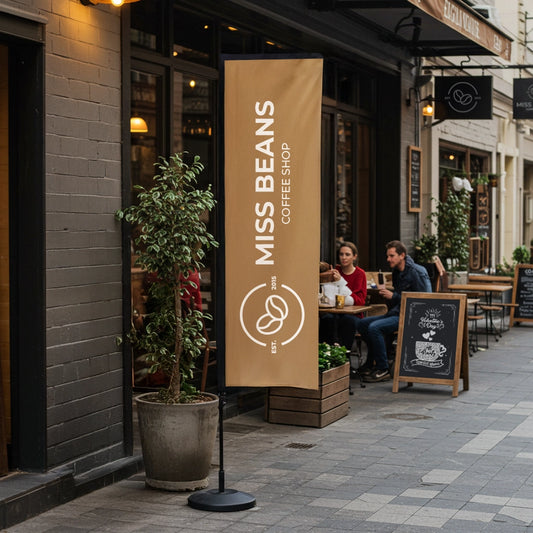 Miss Beans Coffee Shop exterior with a banner and people sitting at tables.