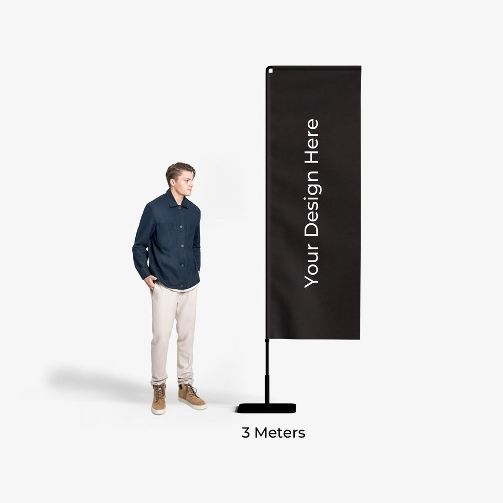 Man standing next to a tall black banner with 'Your Design Here' text on a white background