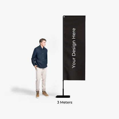 Man standing next to a tall black banner with 'Your Design Here' text on a white background