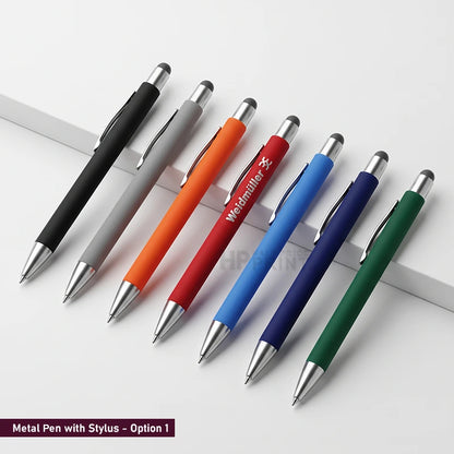 Six retractable metal pens with stylus tips are arranged diagonally on a white surface. The pen bodies are shown in black, gray, orange, red, blue, and green, with silver metal tips and clips.