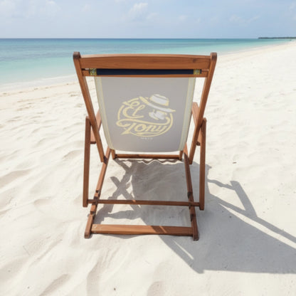 Wooden beach chair with a logo on a sandy beach with ocean view