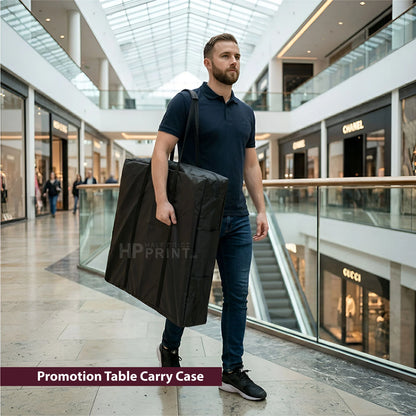 Man holding a black 'Promotion Table Carry Case' in a mall setting