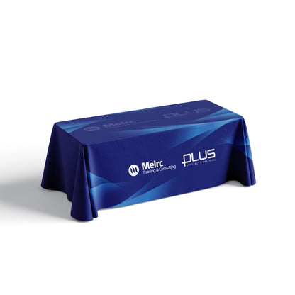 A custom table cover in blue with logos printed on it, displayed on a table.