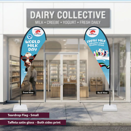 Teardrop flags for World Milk Day in front of a store named 'Dairy Collective'.