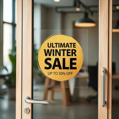 Glass door with 'Ultimate Winter Sale' on window cling inside a store.